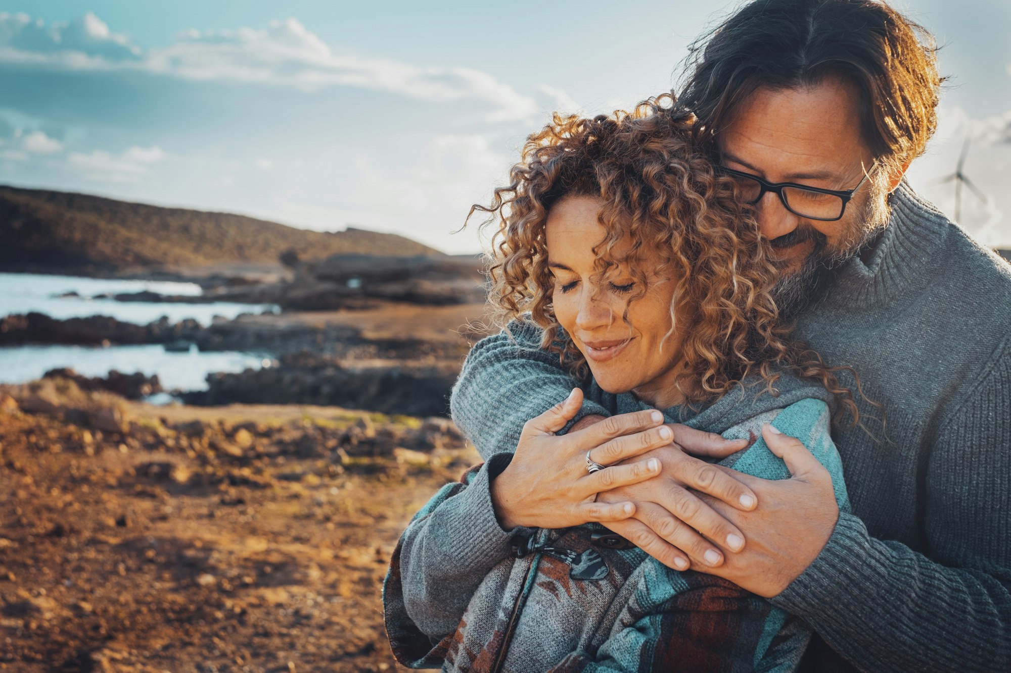 Happy young couple in love hugging outdoors with tenderness and relationship